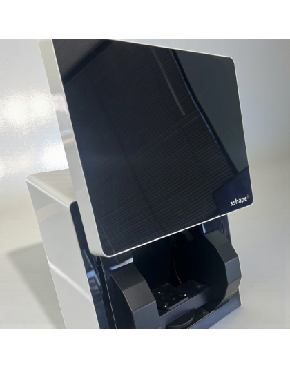 Side view of a 3Shape D710 desktop dental lab scanner with an angled black front panel and open scan chamber on a white background.
